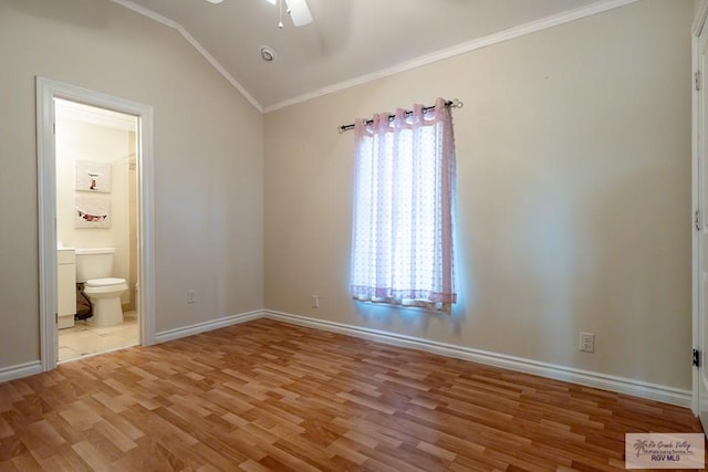 unfurnished bedroom with hardwood / wood-style flooring, ceiling fan, ensuite bathroom, ornamental molding, and vaulted ceiling