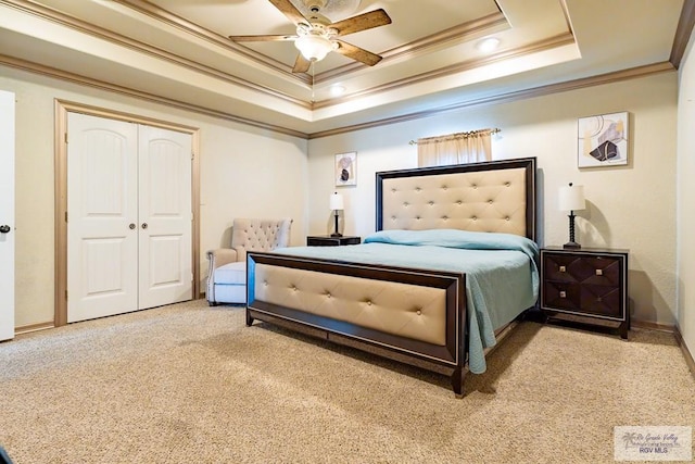 carpeted bedroom with ornamental molding, a raised ceiling, and ceiling fan