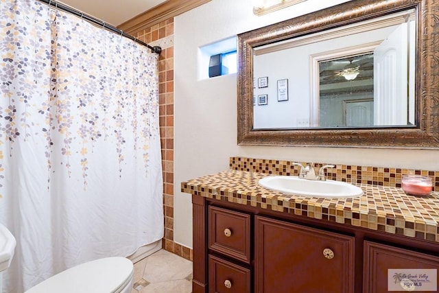 bathroom featuring tile patterned flooring, backsplash, a shower with shower curtain, vanity, and toilet