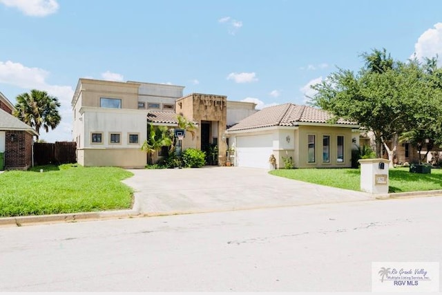 view of front of home featuring a front lawn and a garage