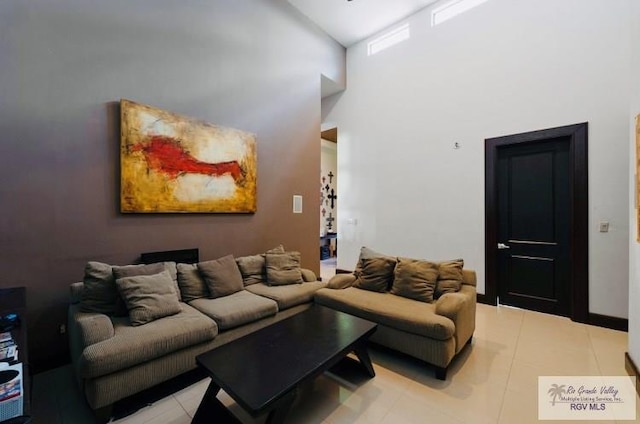 tiled living room with high vaulted ceiling