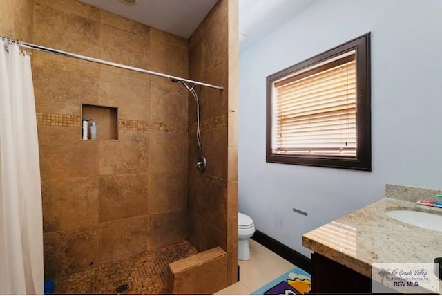 bathroom with a shower with shower curtain, vanity, toilet, and tile patterned floors