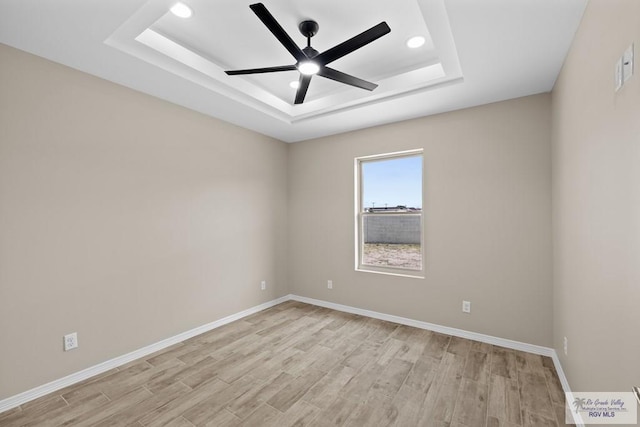 5112 Blackhawk Ave, Rio Grande City, TX 78582 - empty room featuring a tray ceiling, ceiling fan, light wood finished floors, and recessed lighting