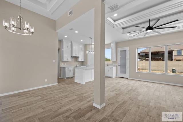 5112 Blackhawk Ave, Rio Grande City, TX 78582 - unfurnished living room with light wood-style floors, a tray ceiling, visible vents, and ceiling fan with notable chandelier