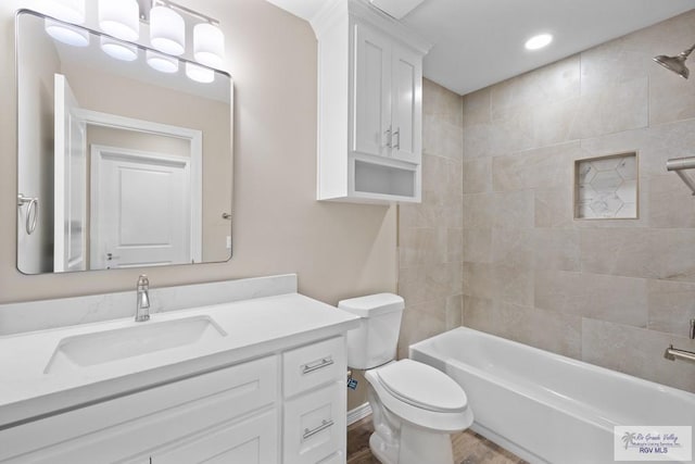 5112 Blackhawk Ave, Rio Grande City, TX 78582 - bathroom with toilet, shower / washtub combination, wood finished floors, vanity, and recessed lighting
