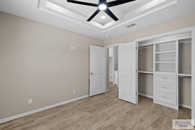 5112 Blackhawk Ave, Rio Grande City, TX 78582 - unfurnished bedroom featuring light wood-style floors, visible vents, baseboards, and a raised ceiling