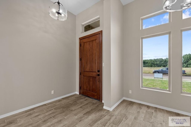 5112 Blackhawk Ave, Rio Grande City, TX 78582 - entrance foyer featuring a chandelier, light wood-type flooring, and plenty of natural light
