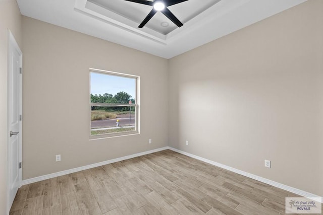5112 Blackhawk Ave, Rio Grande City, TX 78582 - unfurnished room featuring baseboards, light wood-style flooring, a raised ceiling, and ceiling fan
