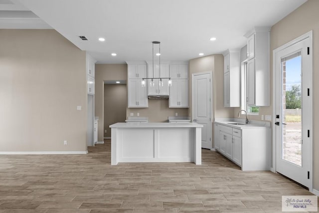 5112 Blackhawk Ave, Rio Grande City, TX 78582 - kitchen featuring a sink, baseboards, and light wood-type flooring