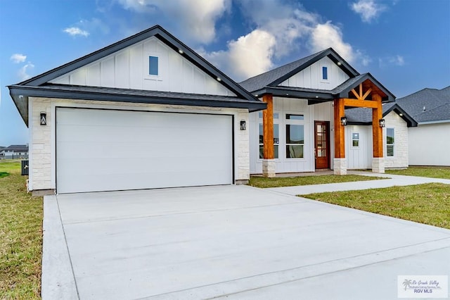 view of front of house with a garage and a front lawn