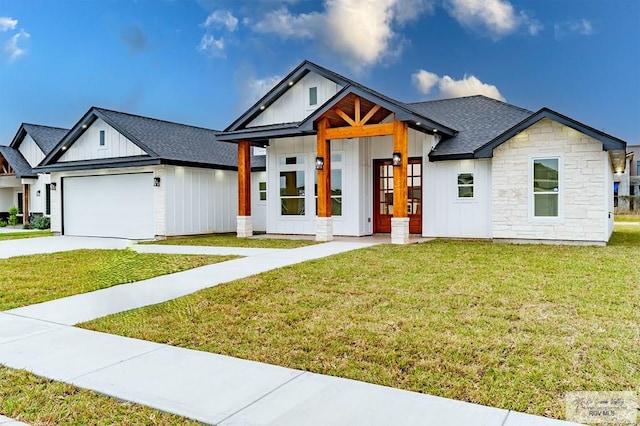 view of front of home featuring french doors, a front yard, and a garage