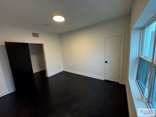 spare room with visible vents and baseboards