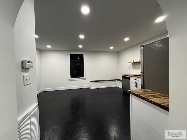 kitchen featuring recessed lighting, stainless steel appliances, visible vents, white cabinets, and wooden counters