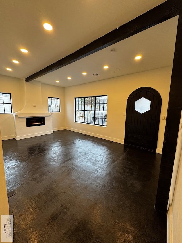 unfurnished living room featuring a large fireplace, recessed lighting, beam ceiling, and baseboards