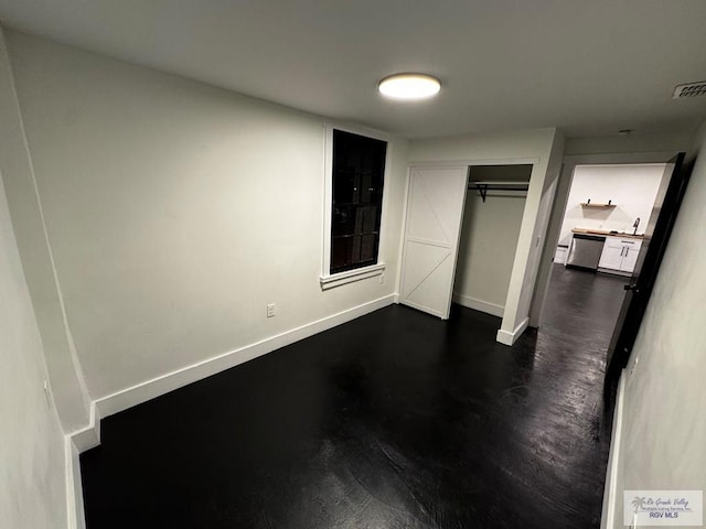 unfurnished bedroom featuring a closet, visible vents, and baseboards