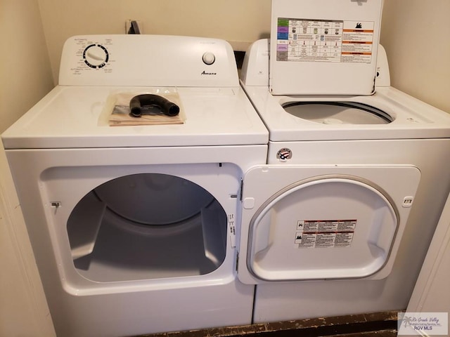 clothes washing area featuring washing machine and clothes dryer