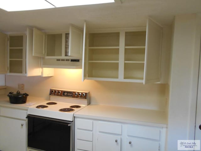 kitchen with white cabinetry and white range with electric cooktop