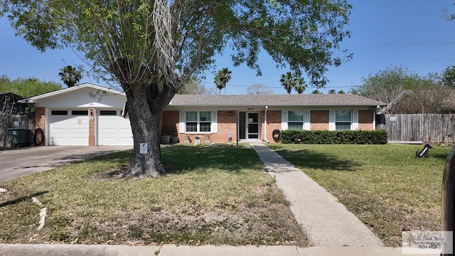 ranch-style home with fence, driveway, a front lawn, a garage, and brick siding