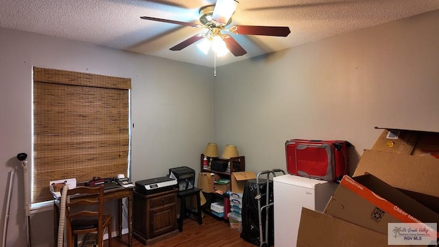 office area featuring a textured ceiling, wood finished floors, and a ceiling fan