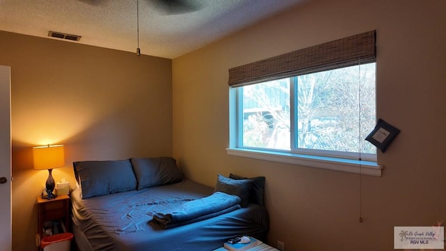 bedroom featuring visible vents and a textured ceiling