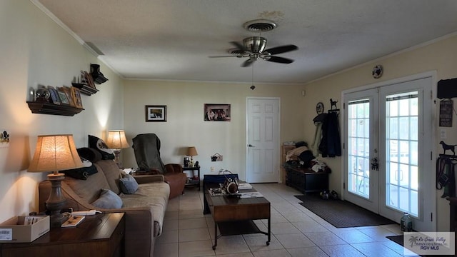 living room with visible vents, ornamental molding, french doors, light tile patterned flooring, and ceiling fan