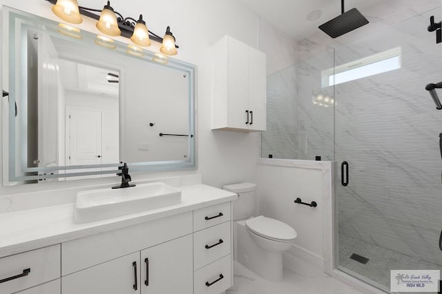 bathroom featuring vanity, toilet, and an enclosed shower