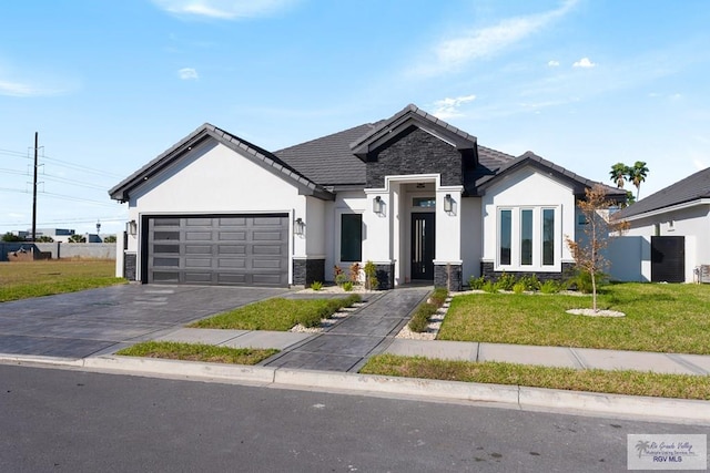 view of front facade featuring a garage and a front lawn