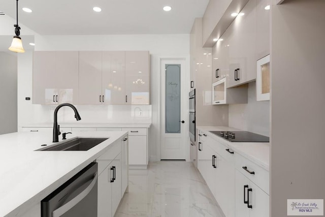 kitchen featuring sink, stainless steel dishwasher, decorative light fixtures, black electric stovetop, and white cabinets