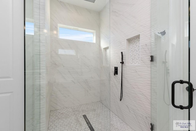 bathroom with a shower with door