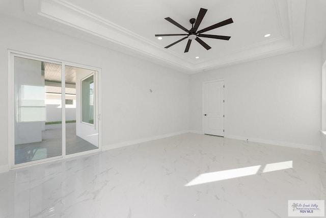 unfurnished room featuring a tray ceiling, ceiling fan, and crown molding