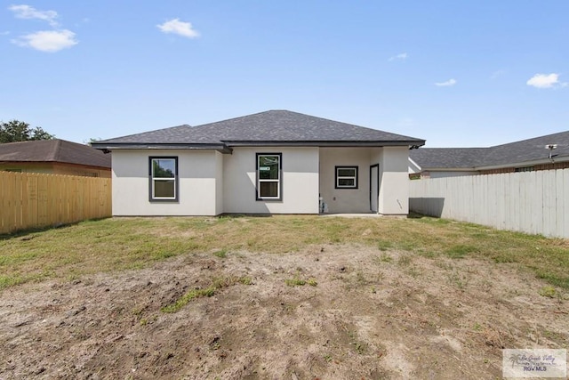 rear view of house with a lawn