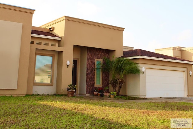 view of front of home with a front yard and a garage