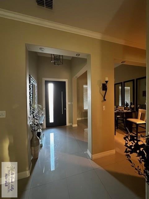 tiled foyer with crown molding