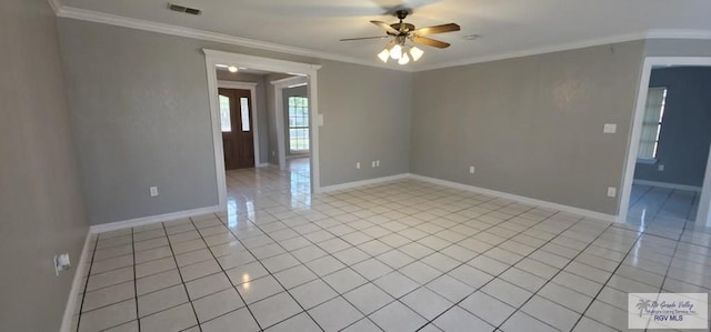 tiled empty room featuring ornamental molding and ceiling fan