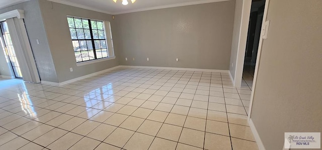 empty room featuring ornamental molding and light tile patterned floors