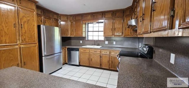 kitchen with light tile patterned flooring, stainless steel appliances, sink, and tasteful backsplash