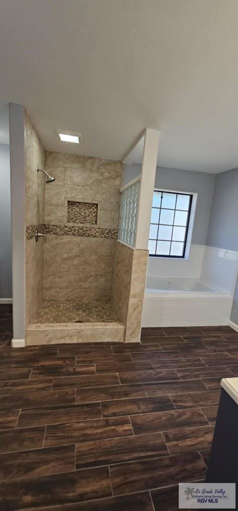 bathroom with vanity and tiled shower