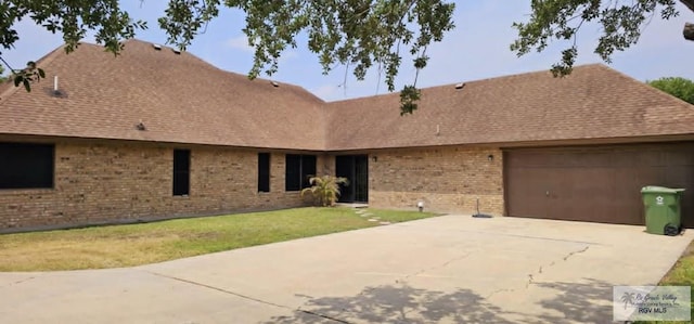 view of front of property with a garage and a front yard