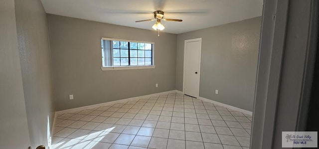 tiled empty room with ceiling fan