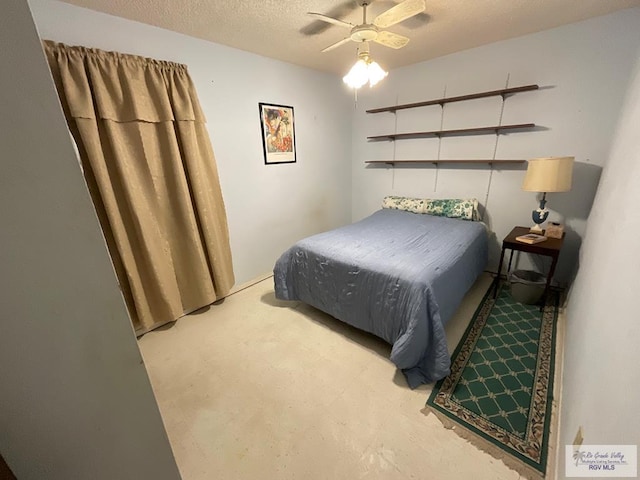 bedroom with ceiling fan and a textured ceiling