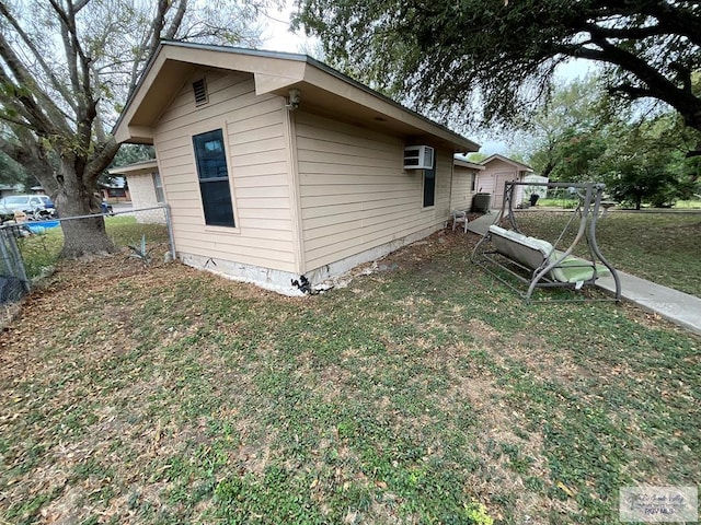 view of property exterior featuring a yard and a wall mounted air conditioner