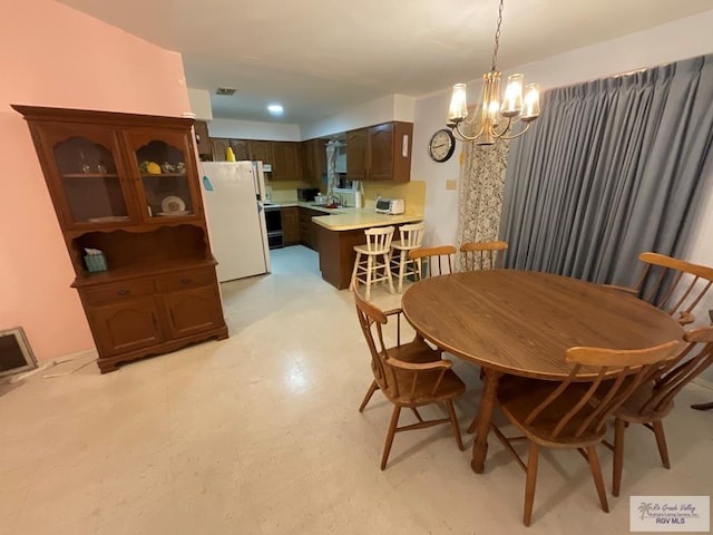 dining room featuring sink and an inviting chandelier