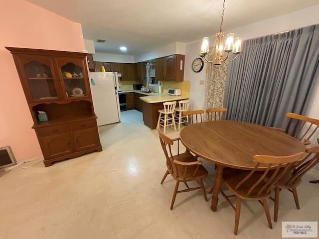 1105 Colt St, La Feria, TX 78559 - dining room featuring a chandelier and light flooring