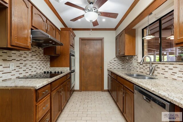 kitchen featuring decorative backsplash, black electric stovetop, stainless steel dishwasher, sink, and pendant lighting