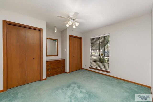 unfurnished bedroom featuring ceiling fan and light carpet