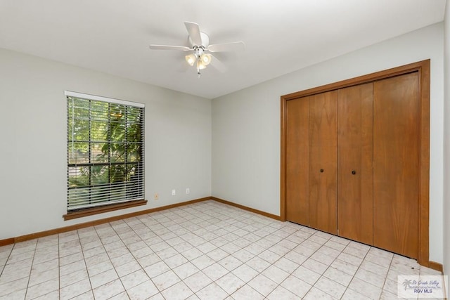 unfurnished bedroom featuring ceiling fan and a closet