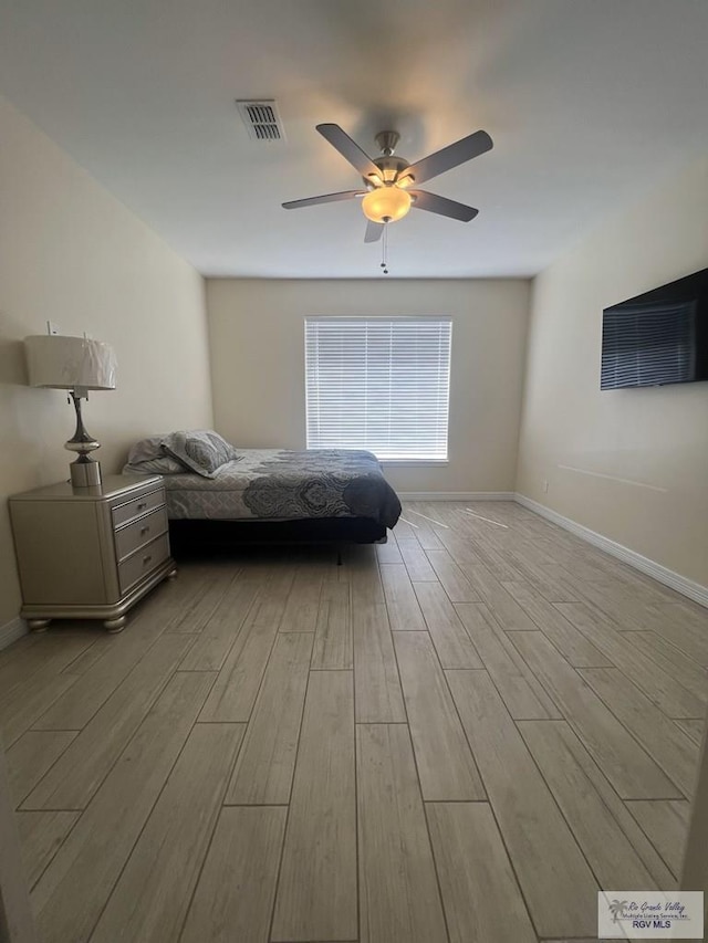 unfurnished bedroom with ceiling fan and light wood-type flooring