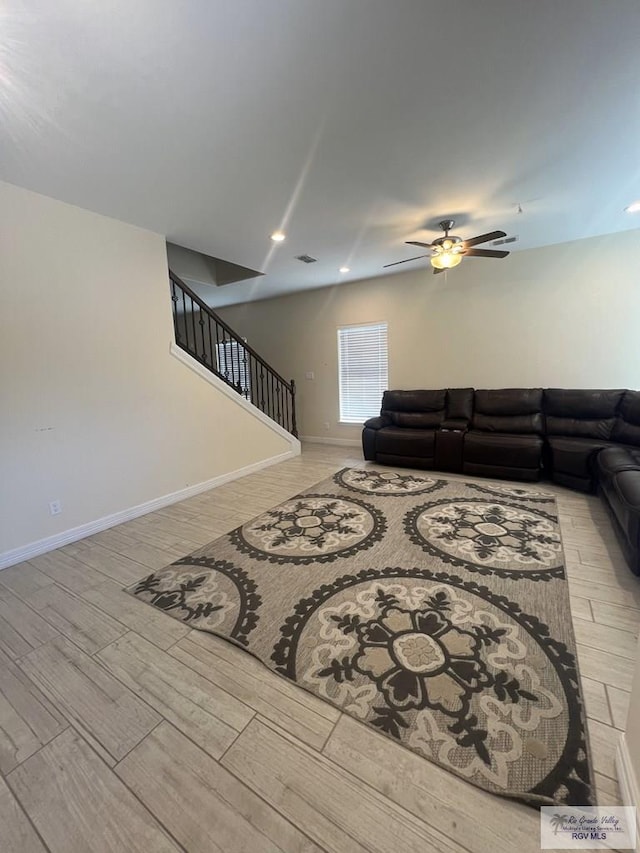 living room with light wood-type flooring and ceiling fan