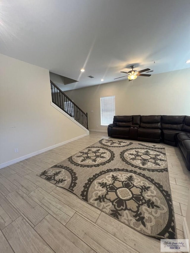 living room featuring ceiling fan and light hardwood / wood-style floors