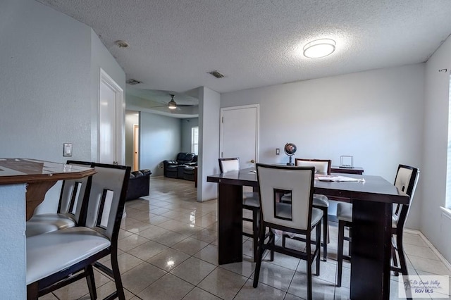 3053 Fairfield Dr, Brownsville, TX 78526 - dining room featuring a textured ceiling, tile patterned flooring, and a ceiling fan